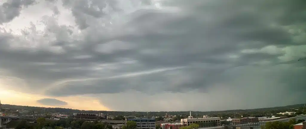 Dark storm clouds gathering over a city skyline, representing an outage that takes down internet and business phones