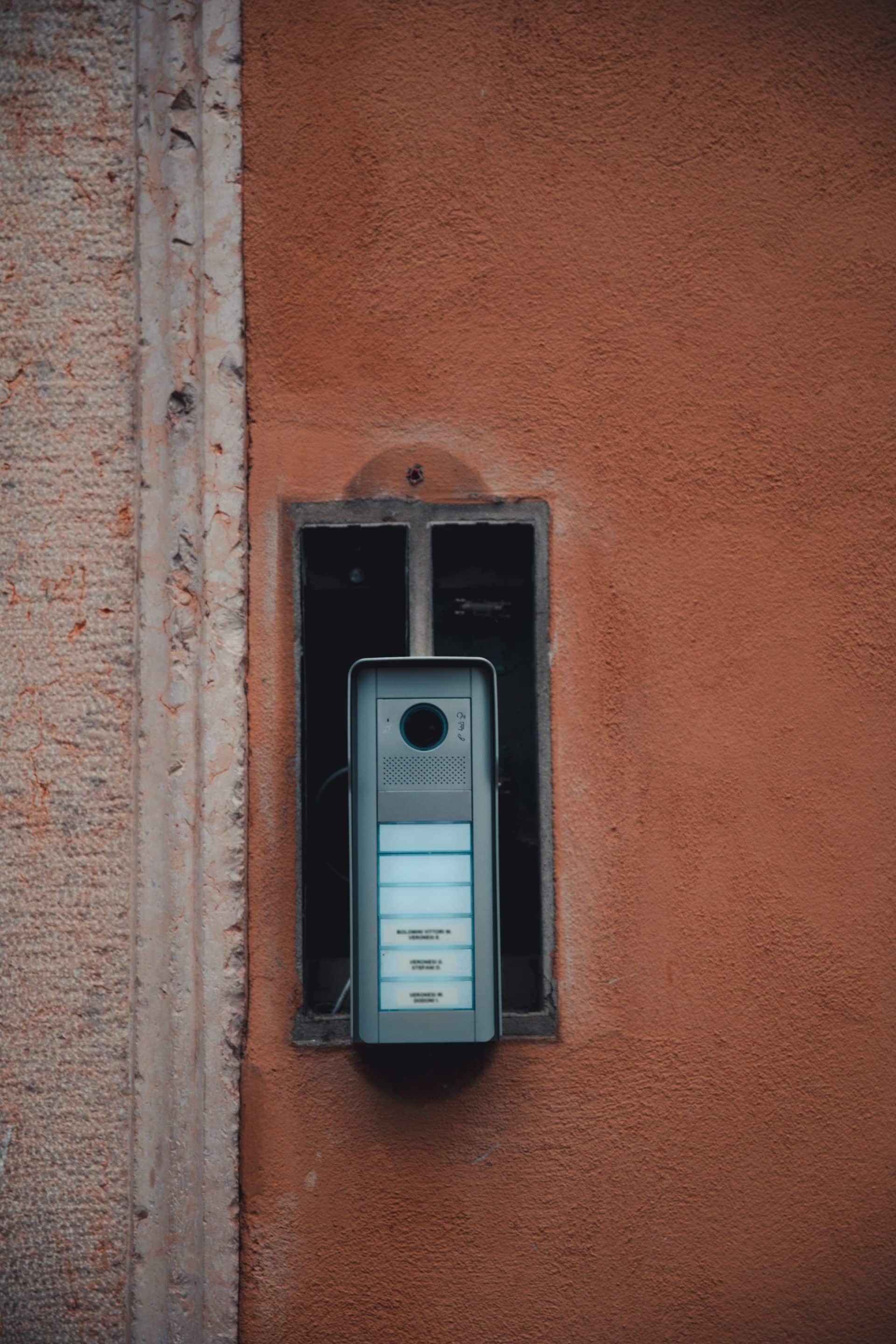DoorBird video door station mounted beside a modern entrance